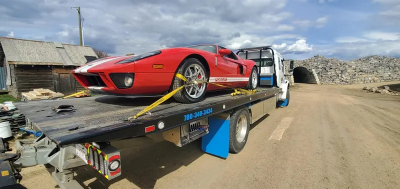 Bora Towing flatbed transporting red Ford GT supercar in Edmonton