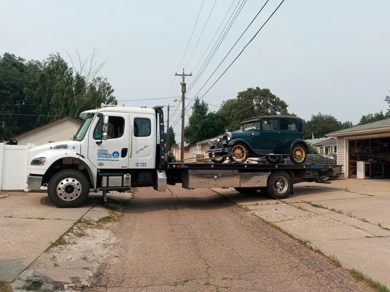 Bora Towing flatbed transporting vintage Ford Model A classic car in Edmonton