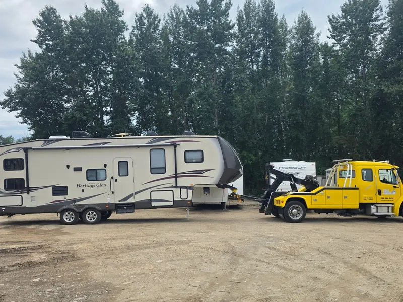 Bora Towing yellow wrecker recovering Heritage Glen fifth-wheel RV in Edmonton