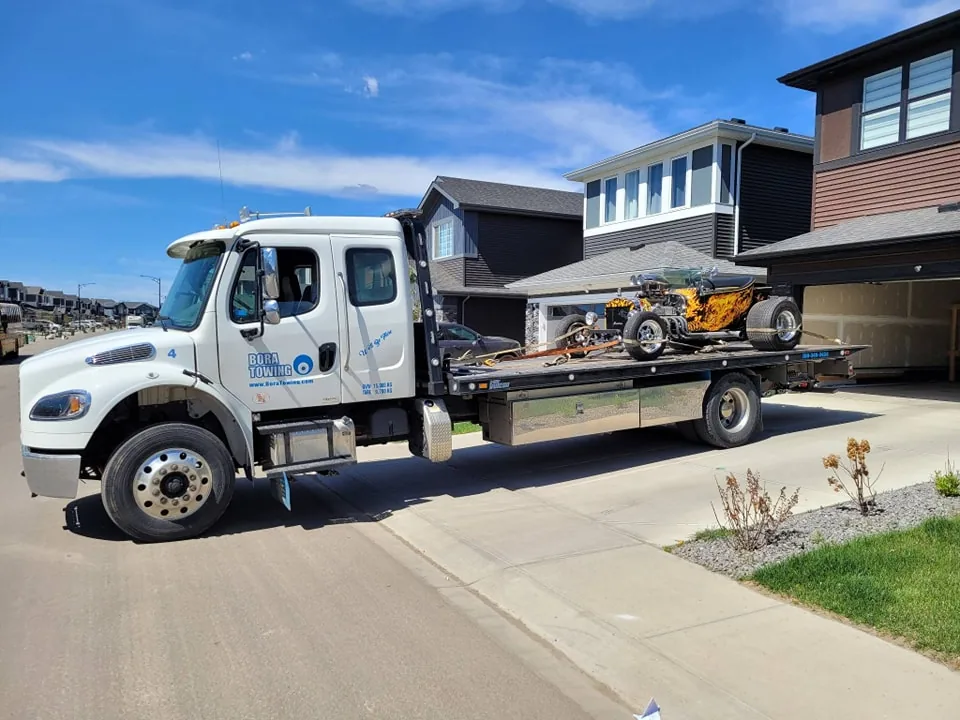 Bora Towing flatbed transporting a custom flame-painted hot rod in Edmonton