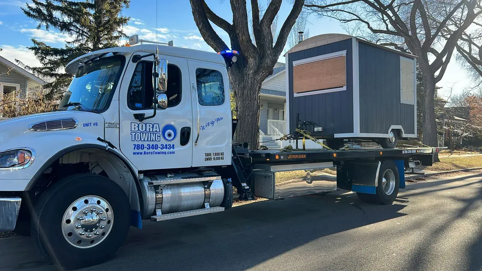 Bora Towing flatbed transporting a small storage shed in Edmonton