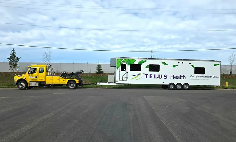 Bora Towing recovering Telus Health occupational health clinic trailer in Edmonton